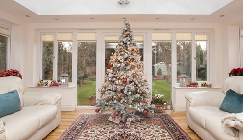 Tall Christmas tree inside a uPVC orangery