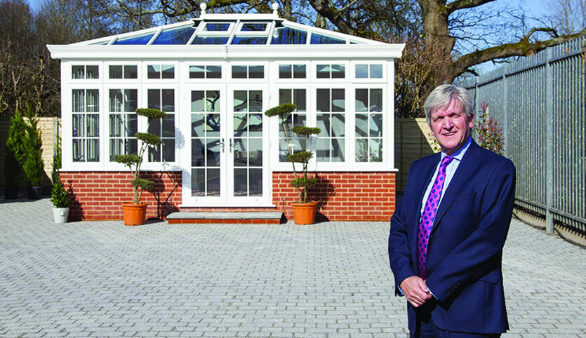Norman in front of a patio and orangery