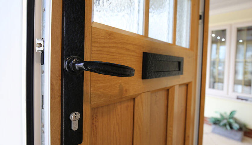 Oak effect uPVC front door and black handle and letter plate 