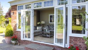 An open white uPVC french door and classic tiled flooring