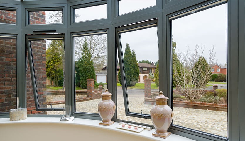 Grey aluminium bay windows in the open position