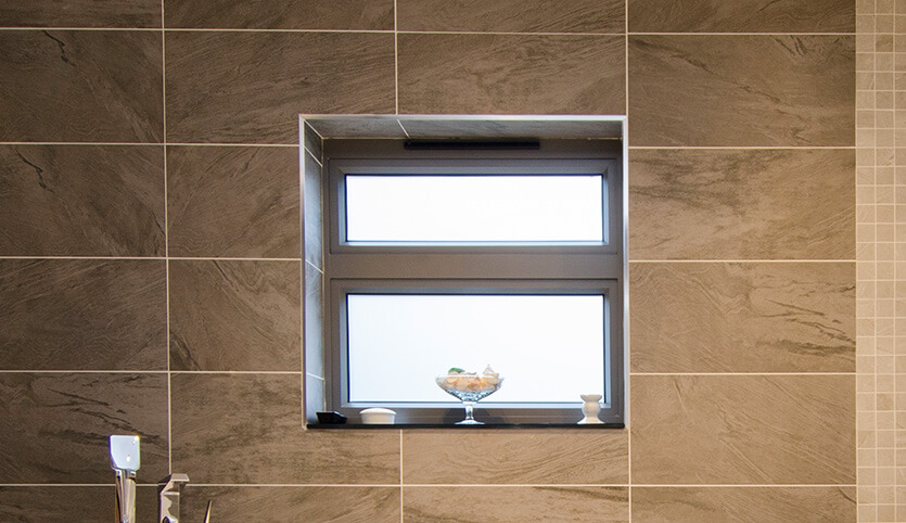 Interior view of bathroom and new aluminium casement window