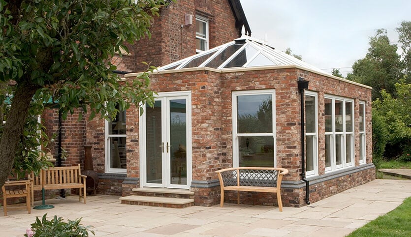 White uPVC Orangery with red brick walls