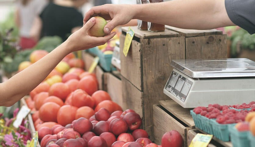 A purchase of a locally sourced apple at market.