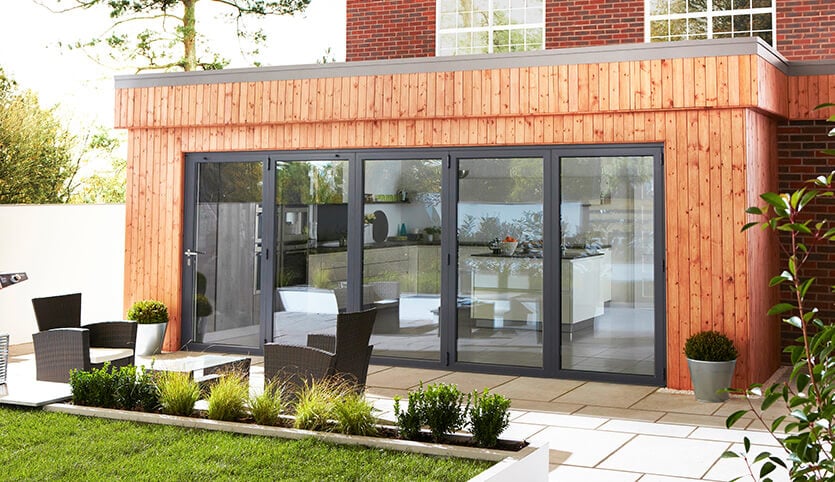 A closed grey aluminium bifold door