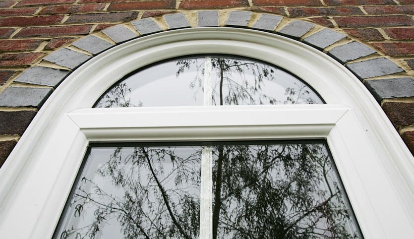 Custom arch shaped uPVC window in white