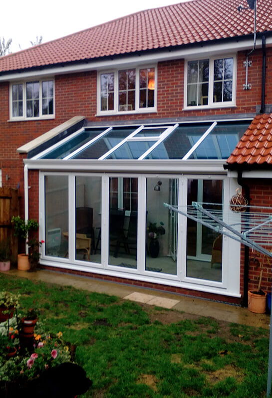 White Lean to conservatory with a glass roof