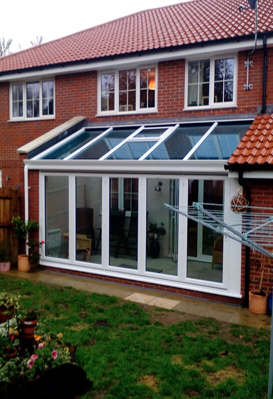 White Lean to conservatory with a glass roof