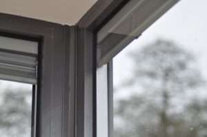 Integral blinds inside gray window frames.