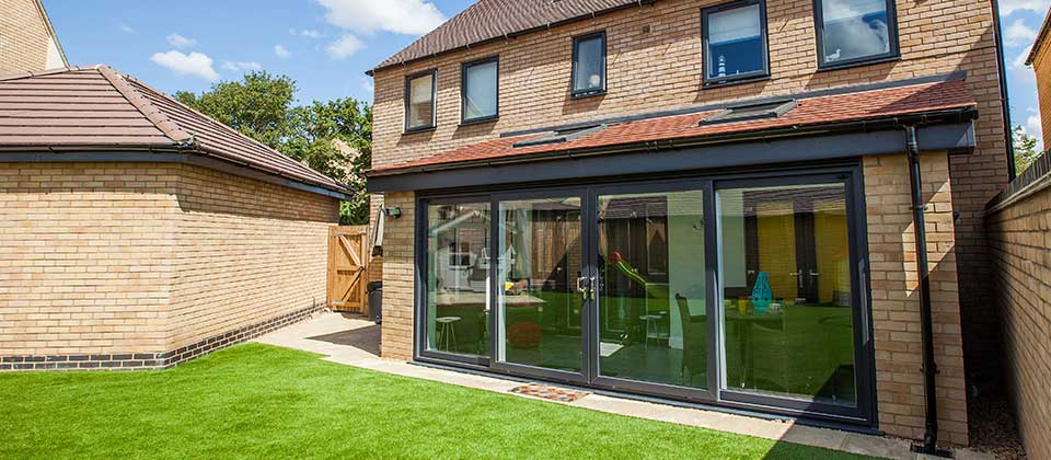 Black aluminium bifold doors installed in an extension