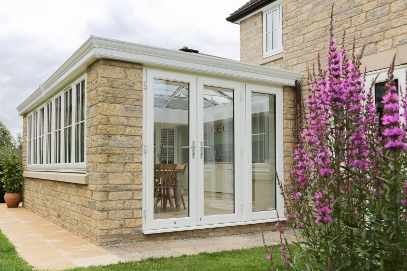 Outside a new kitchen extension with flowers.