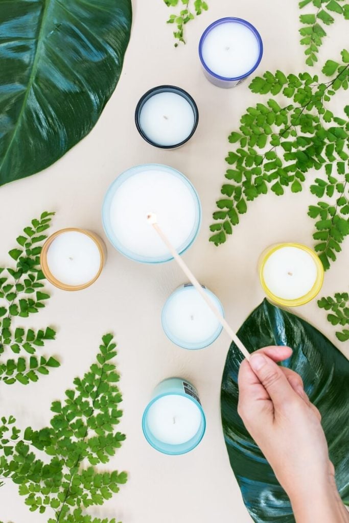 Homemade candles being lit.