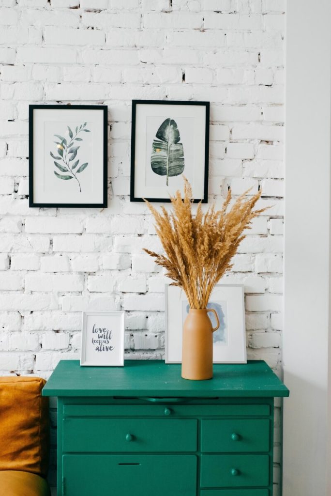 Neat white room with green draws.