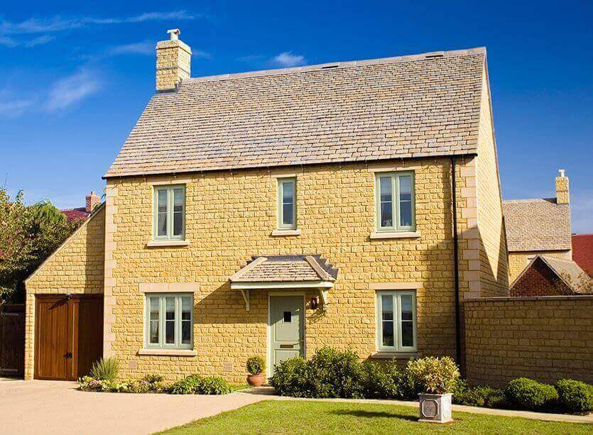 Chartwell green double glazed windows and doors on cream stone house