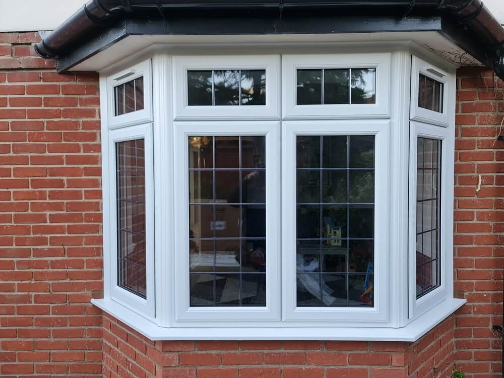 A White PVC bay window on a red brick house.