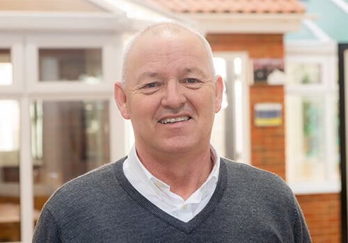 Steve James with a grey jumper on.