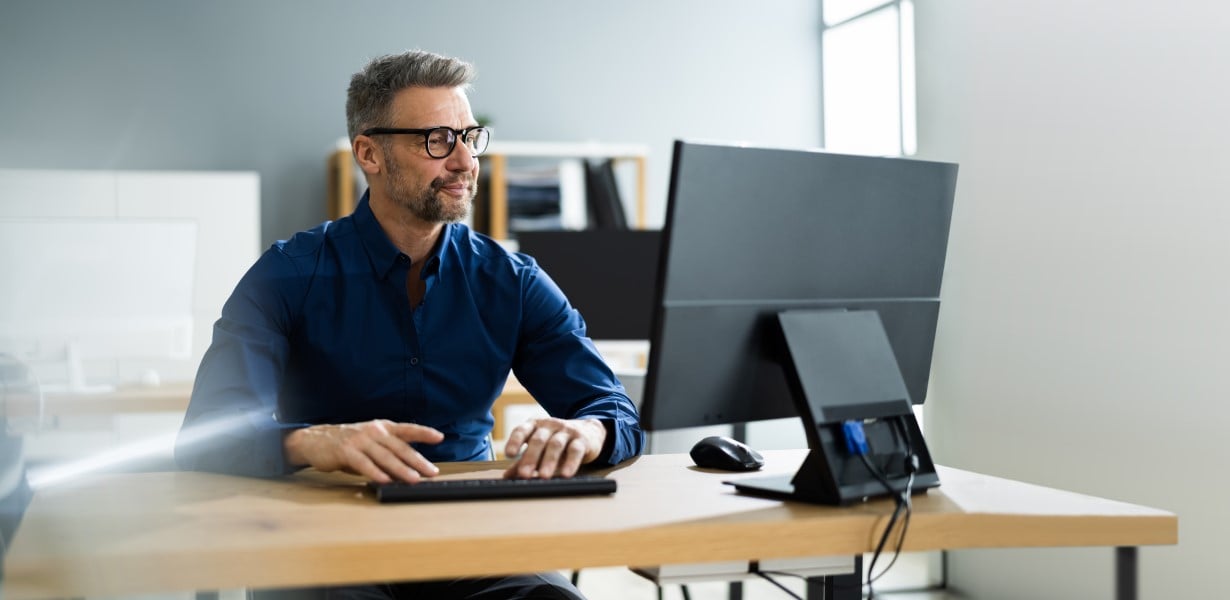 Businessman Using Business Computer In Office