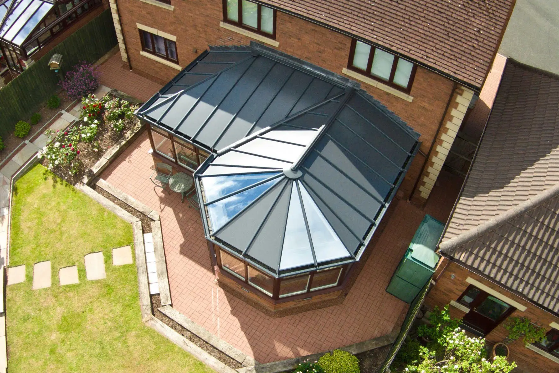 Aerial view of a house with a glass-roof conservatory.