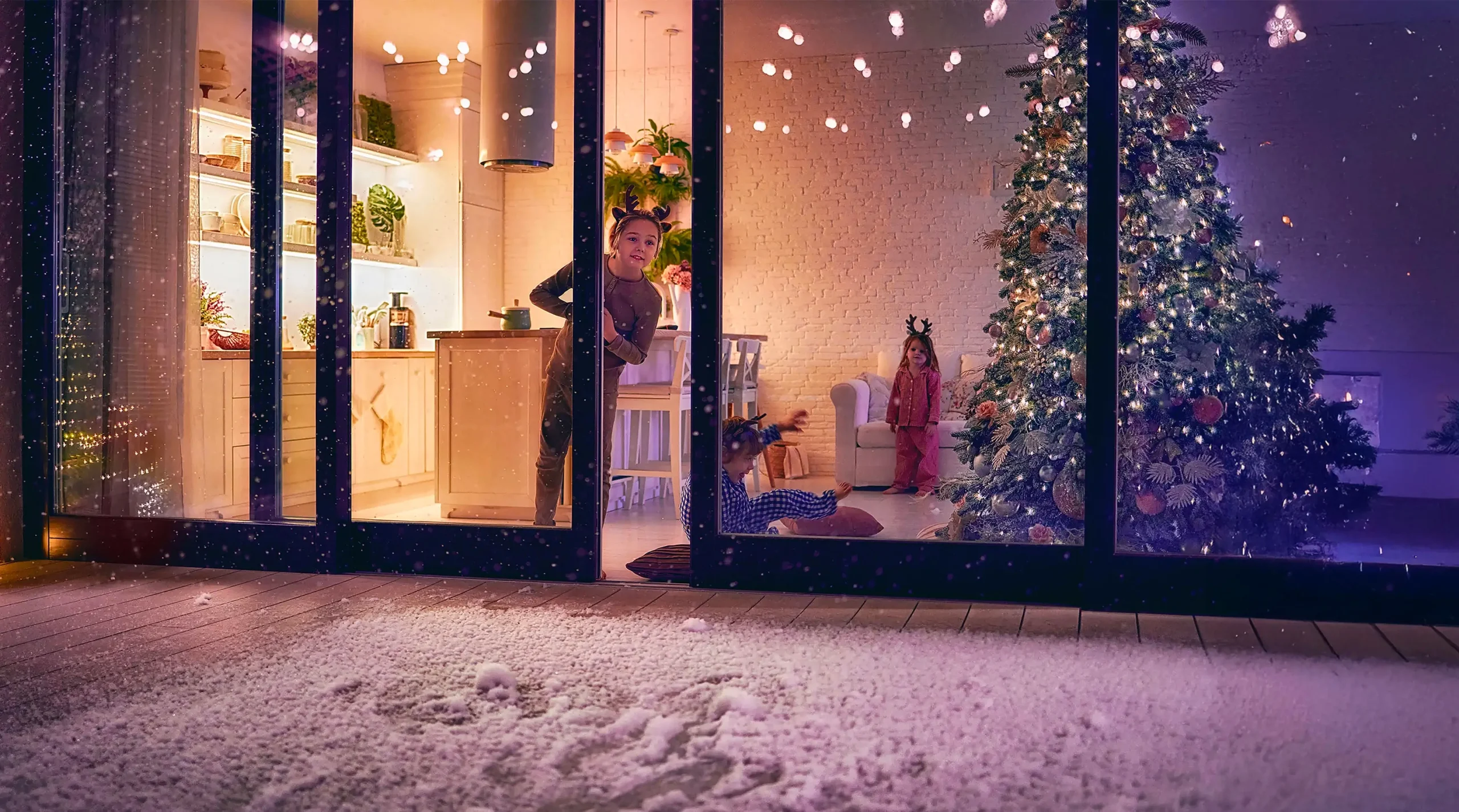 Young child piping out a sliding door looking at the snow